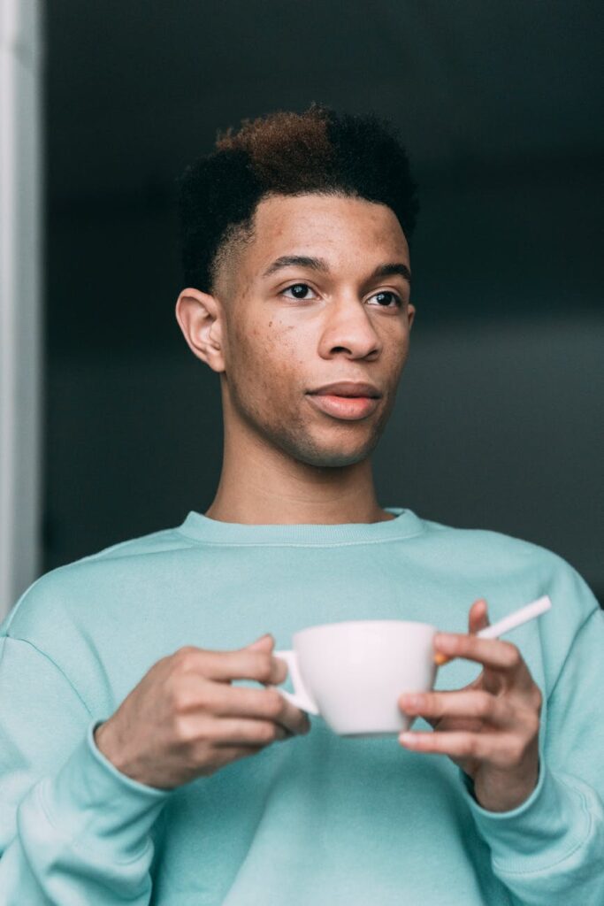 Man holding coffee and a fag